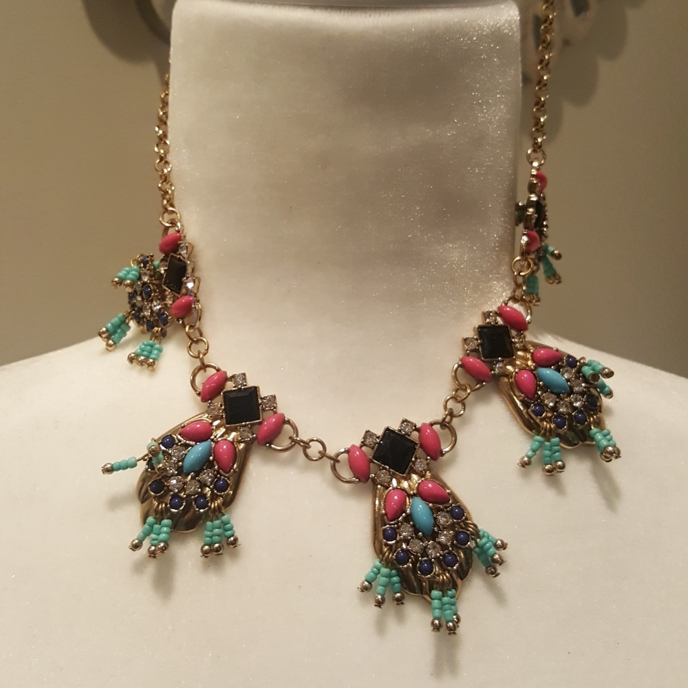 Necklace with pink and blue gems on gold chain